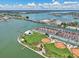 Aerial view showcasing the community's waterfront location, pool, tennis courts, and recreational areas at 343 Rex Pl # F, Madeira Beach, FL 33708