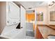 Bathroom featuring stackable washer and dryer, granite countertop, and a hallway view at 343 Rex Pl # F, Madeira Beach, FL 33708