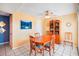 Cozy dining room with a wooden table, ceiling fan, and colorful artwork at 343 Rex Pl # F, Madeira Beach, FL 33708