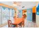 Bright dining area featuring a wooden table and direct access to the outdoor area at 343 Rex Pl # F, Madeira Beach, FL 33708