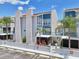 Charming condo featuring stucco walls, colorful blue accents, and well-maintained landscaping at 343 Rex Pl # F, Madeira Beach, FL 33708