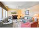Bright living room featuring a stone fireplace and comfortable furnishings at 343 Rex Pl # F, Madeira Beach, FL 33708