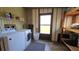 Utility room features washer, dryer, and built in shelving for storage at 34421 Countryside Dr, Wesley Chapel, FL 33543