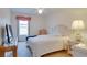 Cozy bedroom with natural light and a comfortable queen-sized bed. Features a side table and a television at 4553 31St E Ct, Bradenton, FL 34203