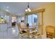 Eat-in kitchen area with a round table, four chairs, and a view into the full kitchen at 4553 31St E Ct, Bradenton, FL 34203