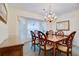 Formal dining room with chandelier, large window and elegant furnishings at 4553 31St E Ct, Bradenton, FL 34203
