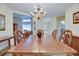 Formal dining room features a wood table, elegant chandelier, and views into the rest of the home at 4553 31St E Ct, Bradenton, FL 34203
