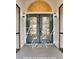 Charming home entrance with double doors, decorative glass, and sconce lighting at 4553 31St E Ct, Bradenton, FL 34203