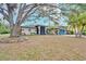Charming single-story home featuring mature trees, a well-manicured lawn, and a welcoming entrance at 4553 31St E Ct, Bradenton, FL 34203