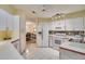 Bright eat-in kitchen with white cabinetry, appliances, and modern mosaic backsplash at 4553 31St E Ct, Bradenton, FL 34203