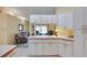 Open-concept kitchen and living room with white cabinets and comfortable seating area at 4553 31St E Ct, Bradenton, FL 34203