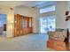 Bright living room with a large window, built-in display cabinet, and comfortable seating, perfect for relaxation at 4553 31St E Ct, Bradenton, FL 34203