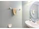 Powder room with round mirror and pedestal sink featuring tile backsplash and faucet at 534 19Th Nw St, Ruskin, FL 33570