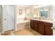 Bright bathroom with a soaking tub, double sink vanity, and tile flooring at 534 19Th Nw St, Ruskin, FL 33570