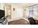 Bright bedroom with a closet, a large window with decorative curtains, and neutral carpeting at 534 19Th Nw St, Ruskin, FL 33570