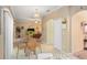 Open dining area with a glass table, wicker chairs, and a view into the adjacent living spaces at 534 19Th Nw St, Ruskin, FL 33570