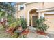 Charming home with a front yard featuring lush landscaping and a covered entryway, showcasing curb appeal at 534 19Th Nw St, Ruskin, FL 33570