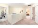 Upstairs hallway with carpet, white railing, and doorways to other bedrooms at 534 19Th Nw St, Ruskin, FL 33570