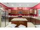 Modern kitchen with dark wood cabinets, granite countertops, stainless steel appliances, and a kitchen island at 534 19Th Nw St, Ruskin, FL 33570