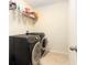 Updated laundry room with tile floor, modern appliances, and shelving at 534 19Th Nw St, Ruskin, FL 33570