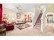 Bright living area with a staircase, plush seating, ceiling fan, and a view into the dining area at 534 19Th Nw St, Ruskin, FL 33570