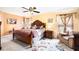 Spacious main bedroom with a ceiling fan, decorative rug, and large windows at 534 19Th Nw St, Ruskin, FL 33570