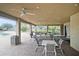 Enjoy the covered patio area with ceiling fans, seating, and views of the community pool at 534 19Th Nw St, Ruskin, FL 33570