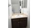 Half-bathroom with neutral countertops, wooden cabinets, and access to downstairs living area at 558 Harbor Ridge Dr, Palm Harbor, FL 34683