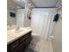 Cozy bathroom with vanity, shower with curtain, and decorative turtle and seahorse wall art at 558 Harbor Ridge Dr, Palm Harbor, FL 34683