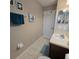 Bathroom featuring vanity, mirror, tile floors, and decorative seahorse and turtle wall art at 558 Harbor Ridge Dr, Palm Harbor, FL 34683