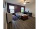 Bedroom featuring hardwood floors, a ceiling fan, a window with blinds, and an accent wall at 558 Harbor Ridge Dr, Palm Harbor, FL 34683
