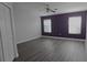 Bedroom with laminate floors, ceiling fan, closet, and dual windows at 558 Harbor Ridge Dr, Palm Harbor, FL 34683