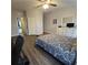 This bedroom includes a ceiling fan, dresser with mirror and TV, and luxury vinyl flooring at 558 Harbor Ridge Dr, Palm Harbor, FL 34683