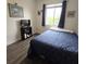 Bedroom with blue decor, window with blinds, and a TV with storage shelf at 558 Harbor Ridge Dr, Palm Harbor, FL 34683