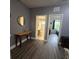 Hallway showcasing entrances to the bathroom and bedroom with luxury vinyl plank flooring at 558 Harbor Ridge Dr, Palm Harbor, FL 34683