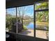 Screened-in lanai offers scenic waterfront views, brick floor, and shade at 558 Harbor Ridge Dr, Palm Harbor, FL 34683