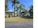 Community pool with white fence and palm trees, perfect for relaxation at 558 Harbor Ridge Dr, Palm Harbor, FL 34683