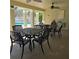 Covered poolside area with tables, chairs, and ceiling fans for comfort at 558 Harbor Ridge Dr, Palm Harbor, FL 34683