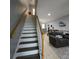 View of open staircase leading to upstairs living area and open concept dining and kitchen at 558 Harbor Ridge Dr, Palm Harbor, FL 34683