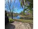 Scenic backyard with waterfront views, brick patio, and lush greenery at 558 Harbor Ridge Dr, Palm Harbor, FL 34683
