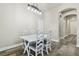 Formal dining room featuring an archway, white wood table and matching chairs, with decorative hanging light fixture at 7714 S West Shore Blvd, Tampa, FL 33616