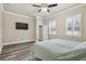 Spacious main bedroom features new floors, ceiling fan and plantation shutters at 7714 S West Shore Blvd, Tampa, FL 33616
