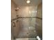 Bathroom featuring a glass enclosed shower with tile walls and a mosaic accent tile at 1604 Boswell Ln, New Port Richey, FL 34655