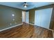 Bedroom with hard surface flooring, double door closet and a view into the hallway at 1604 Boswell Ln, New Port Richey, FL 34655