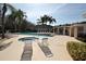 A community pool with sun loungers and lush landscaping offers a resort-style amenity at 1604 Boswell Ln, New Port Richey, FL 34655