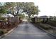 Community entrance featuring an ornate gate, brick pillars and lush landscaping at 1604 Boswell Ln, New Port Richey, FL 34655