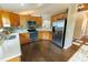 Well-equipped kitchen featuring stainless steel appliances and wood cabinets, with ample counter space at 1604 Boswell Ln, New Port Richey, FL 34655