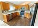 Modern kitchen with stainless steel appliances, wood cabinets, sleek countertops, and tile backsplash at 1604 Boswell Ln, New Port Richey, FL 34655