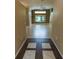 Open-concept living area with neutral paint, tile flooring, and natural light from large windows at 1604 Boswell Ln, New Port Richey, FL 34655