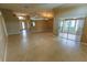 Expansive living room featuring tile flooring, ample natural light, and sliding glass doors leading to outdoor space at 1604 Boswell Ln, New Port Richey, FL 34655